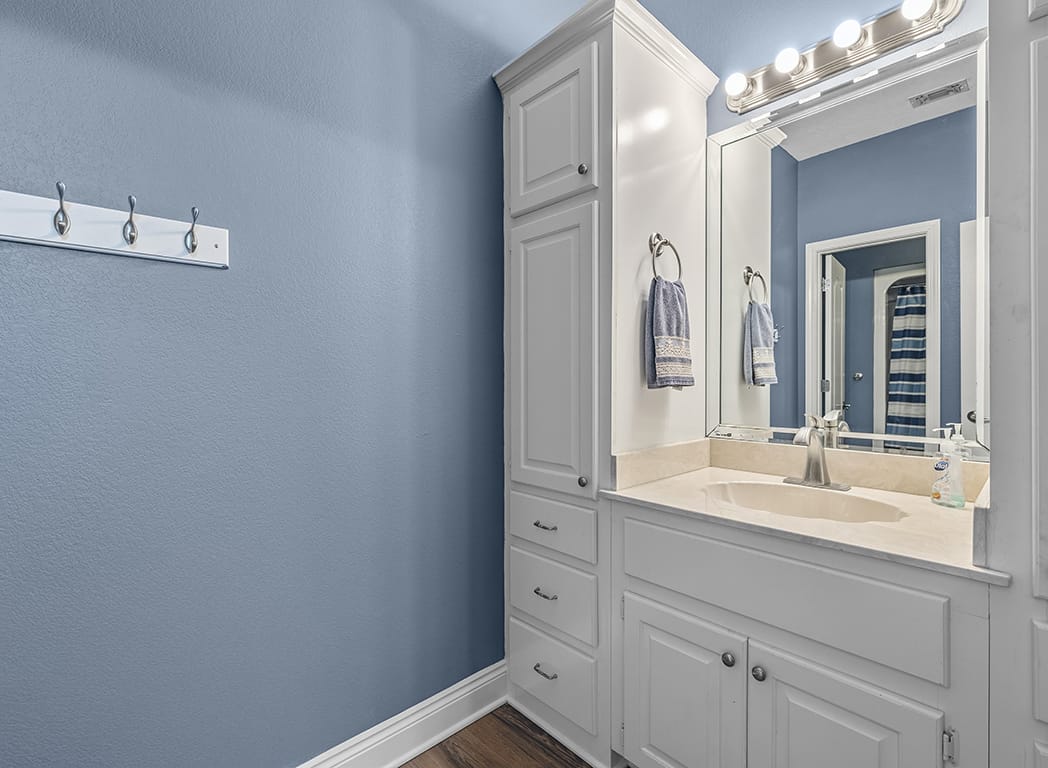 Bathroom with Red Walls and White Vanity