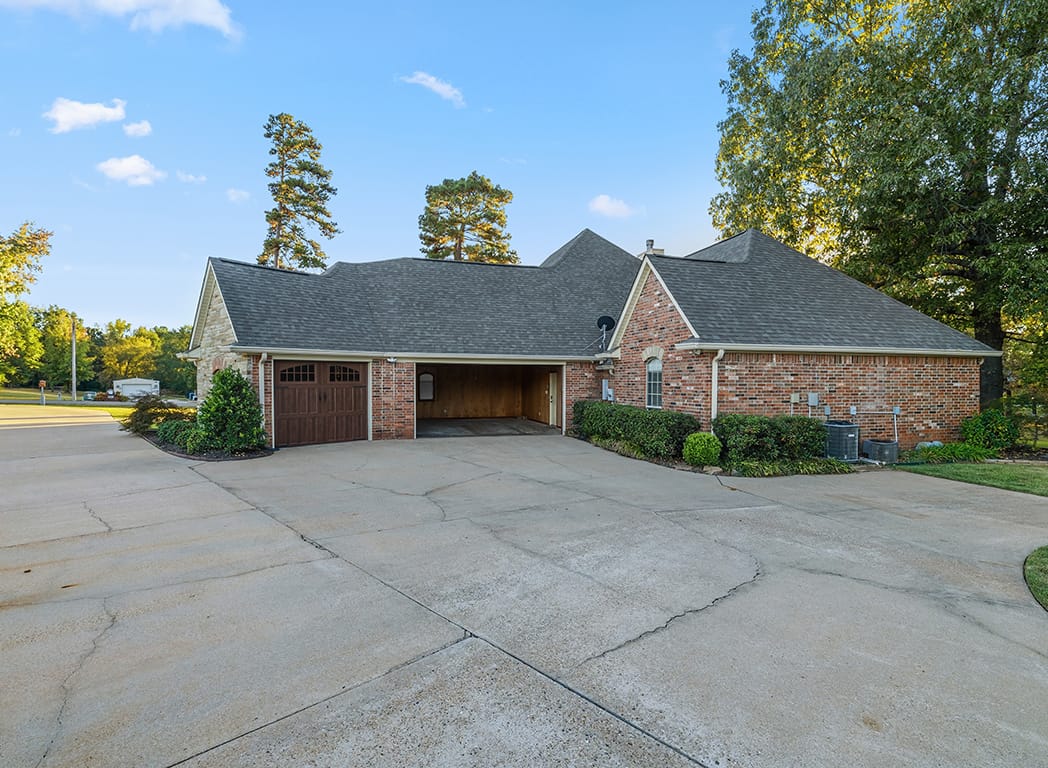 Front Exterior Brick Home with Three Car Garage