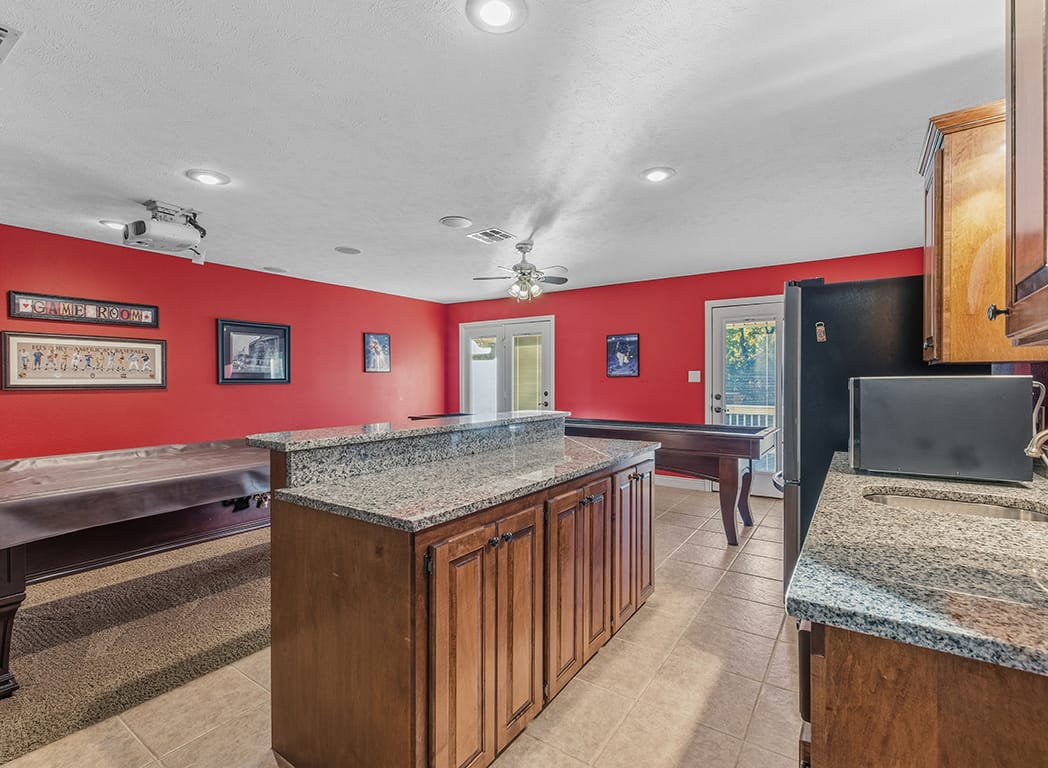 Game Room with Ceiling Fan, Sink, Bar, Sink and Red Wall Trim