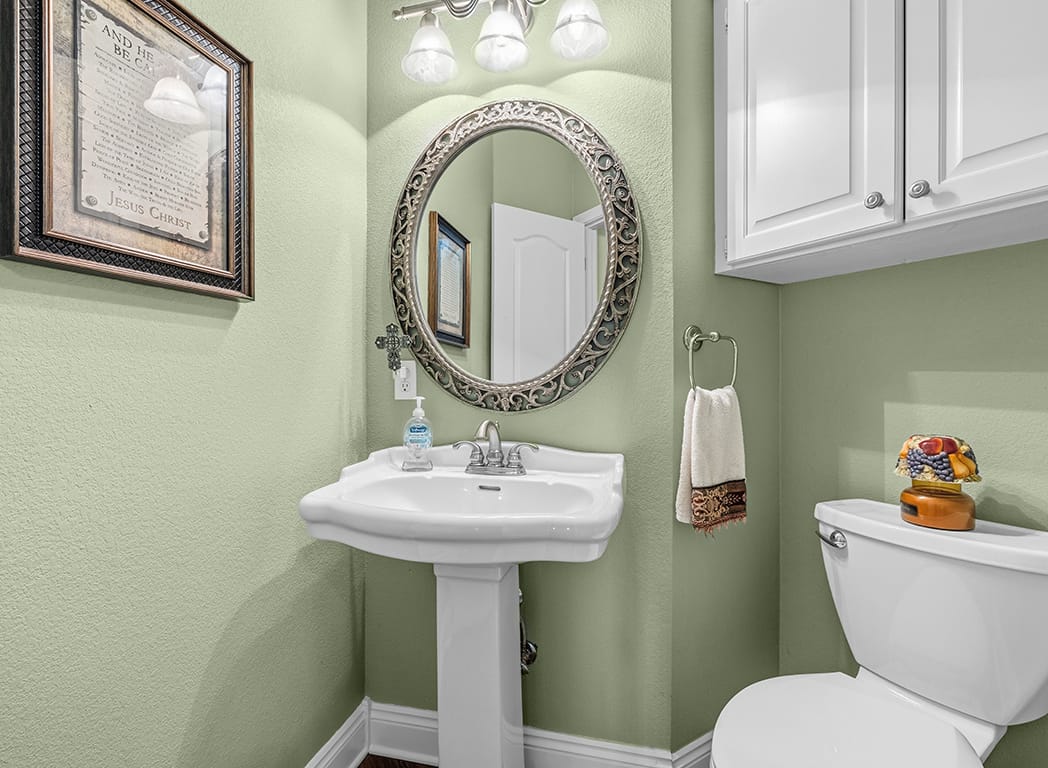 Half Bathroom with Red Walls and White Vanity