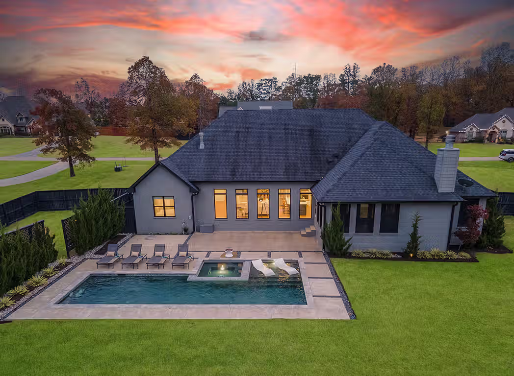 Texarkana real estate photos rear aerial showing pool sunset view and yard texarkana